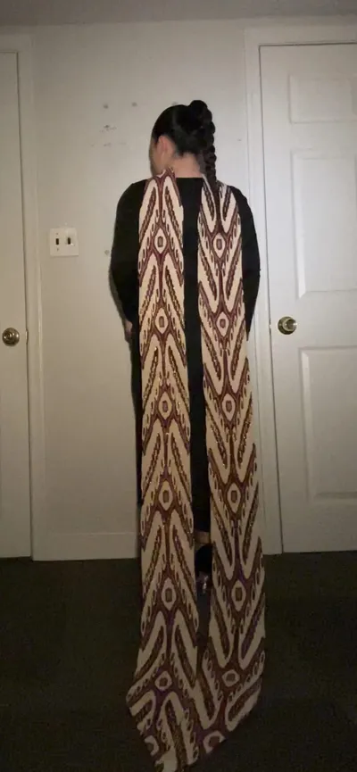 Atlas ikat neck scarf worn draped down the back over a black outfit