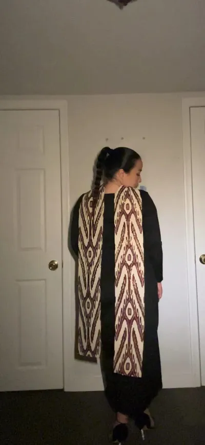Atlas ikat neck scarf worn draped over the shoulders, back view